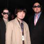 ( Lain Character Designer Yoshitoshi ABe poses with the Lain MiB. )