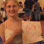 Holding up a prized sketch.